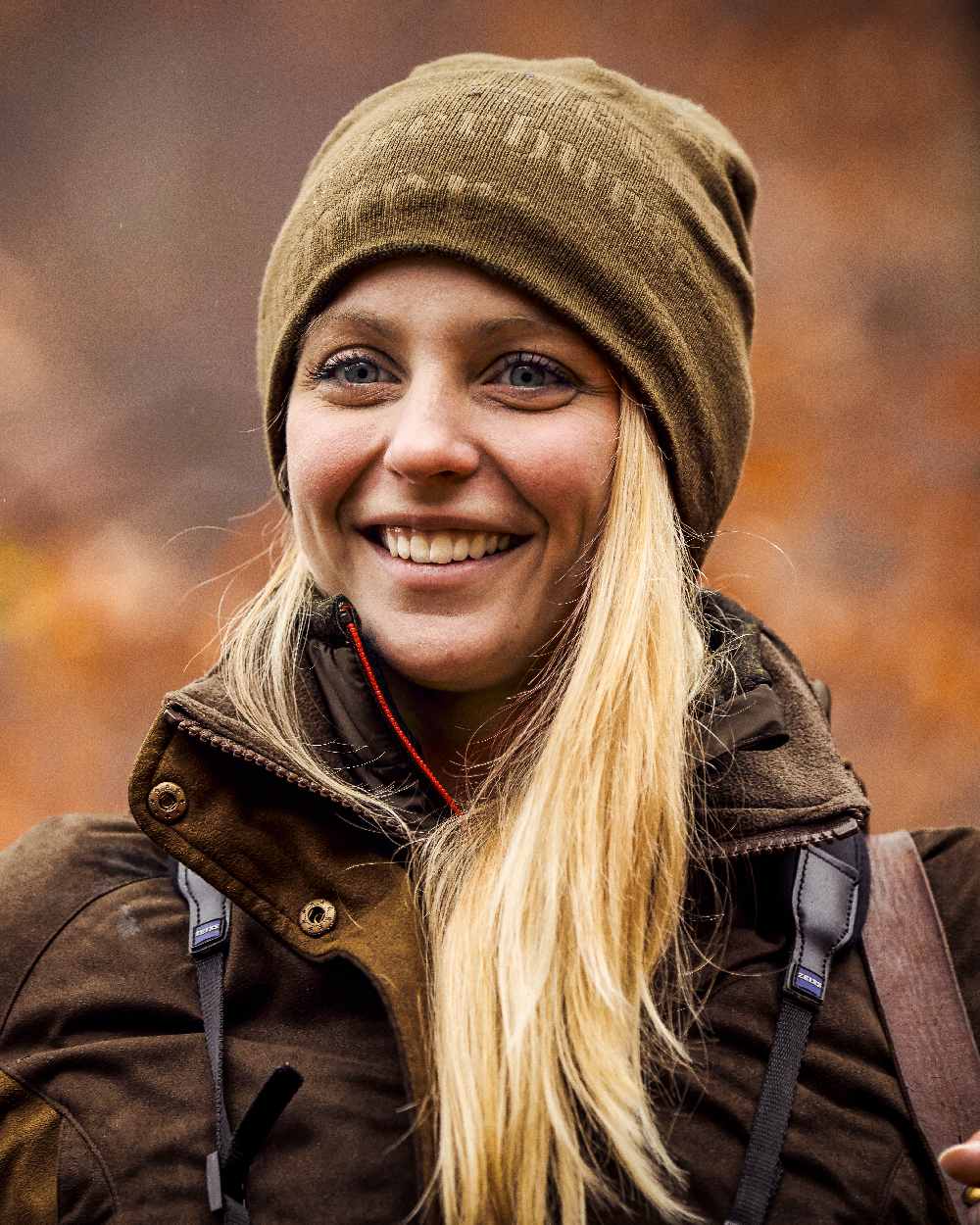 Tarmac Green coloured Deerhunter Embossed Logo Beanie on blurry background 