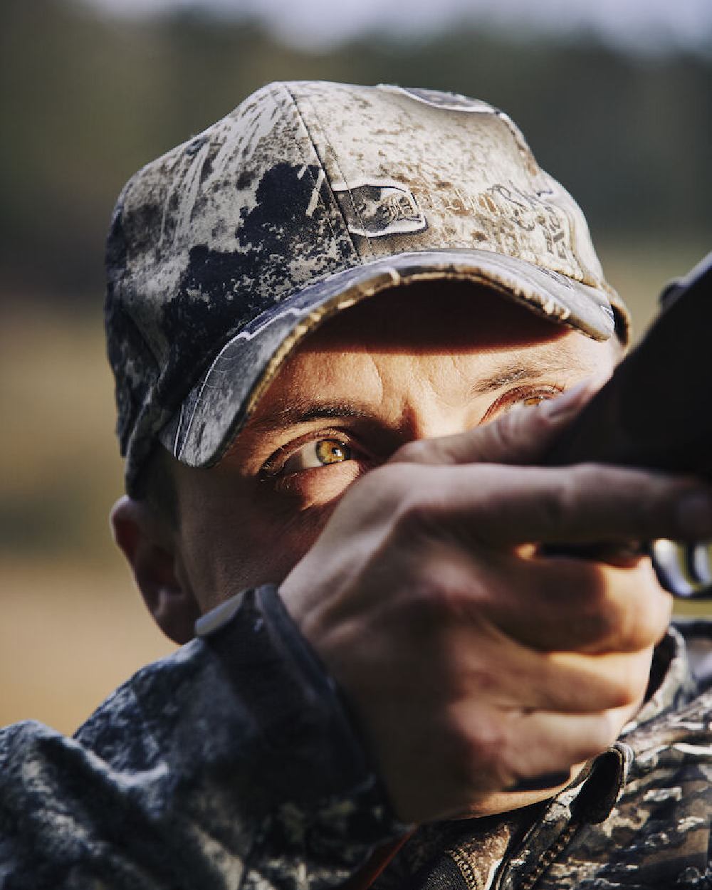 Realtree Excape coloured Deerhunter Excape Light Cap on blurry background 