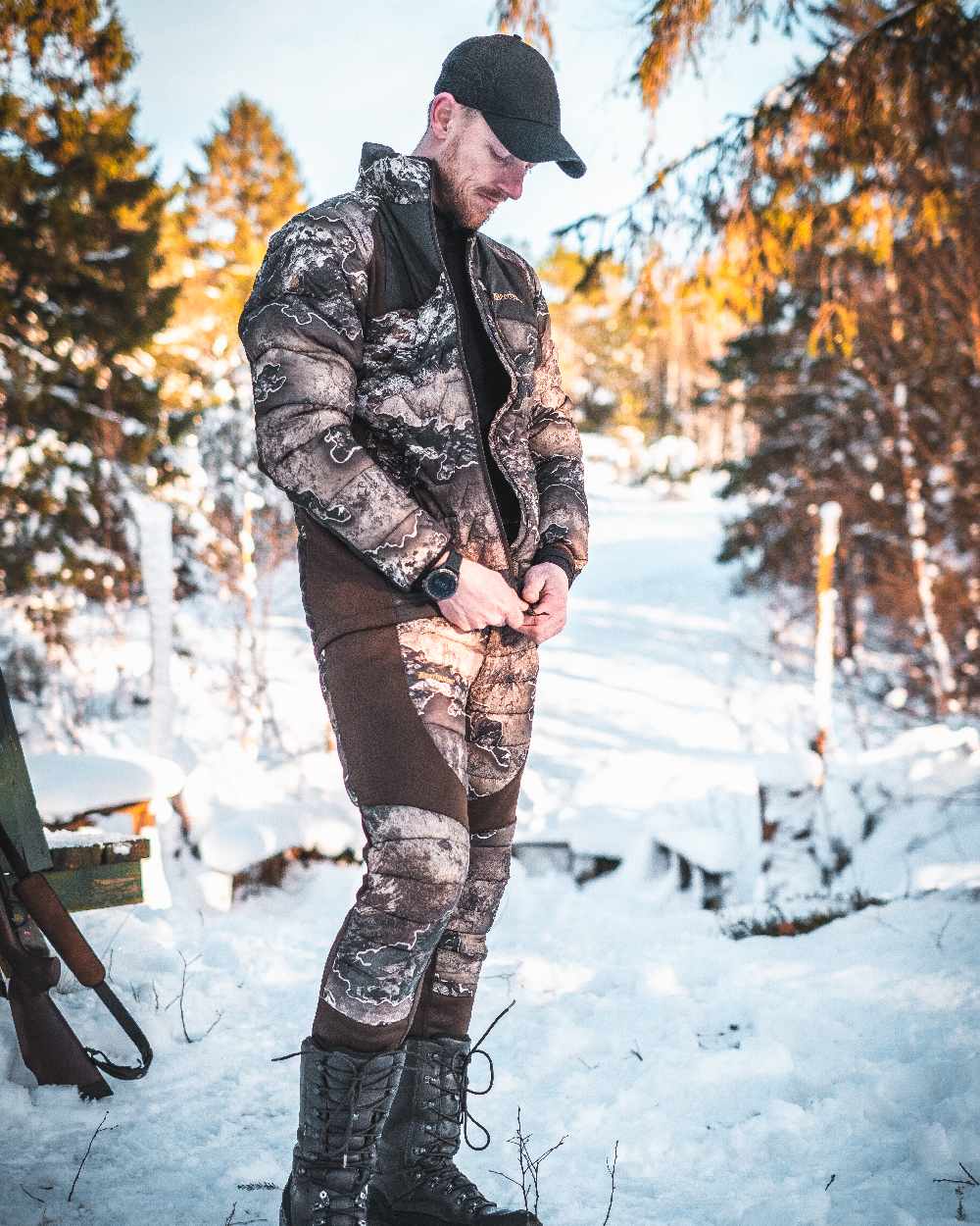 Realtree Excape coloured Deerhunter Excape Quilted Trousers on snow background 