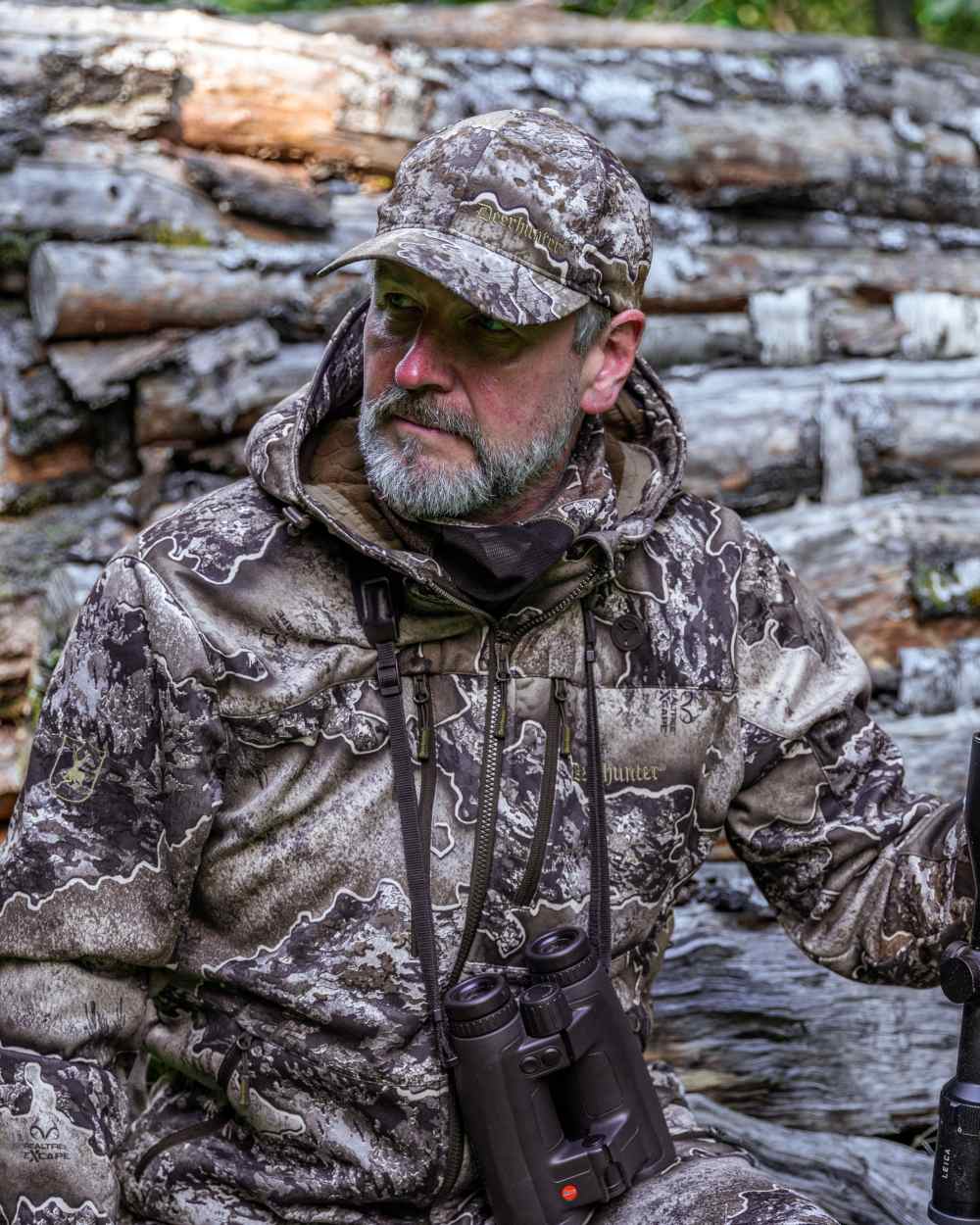 Realtree Excape coloured Deerhunter Excape Softshell Jacket on wood background 