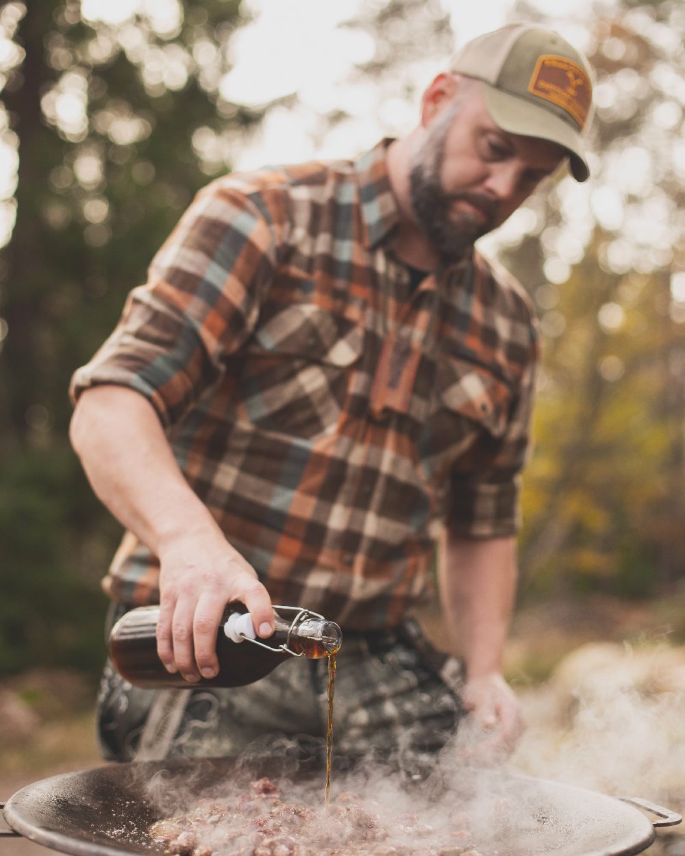 Realtree Excape coloured Deerhunter Excape Softshell Trousers on blurry background 