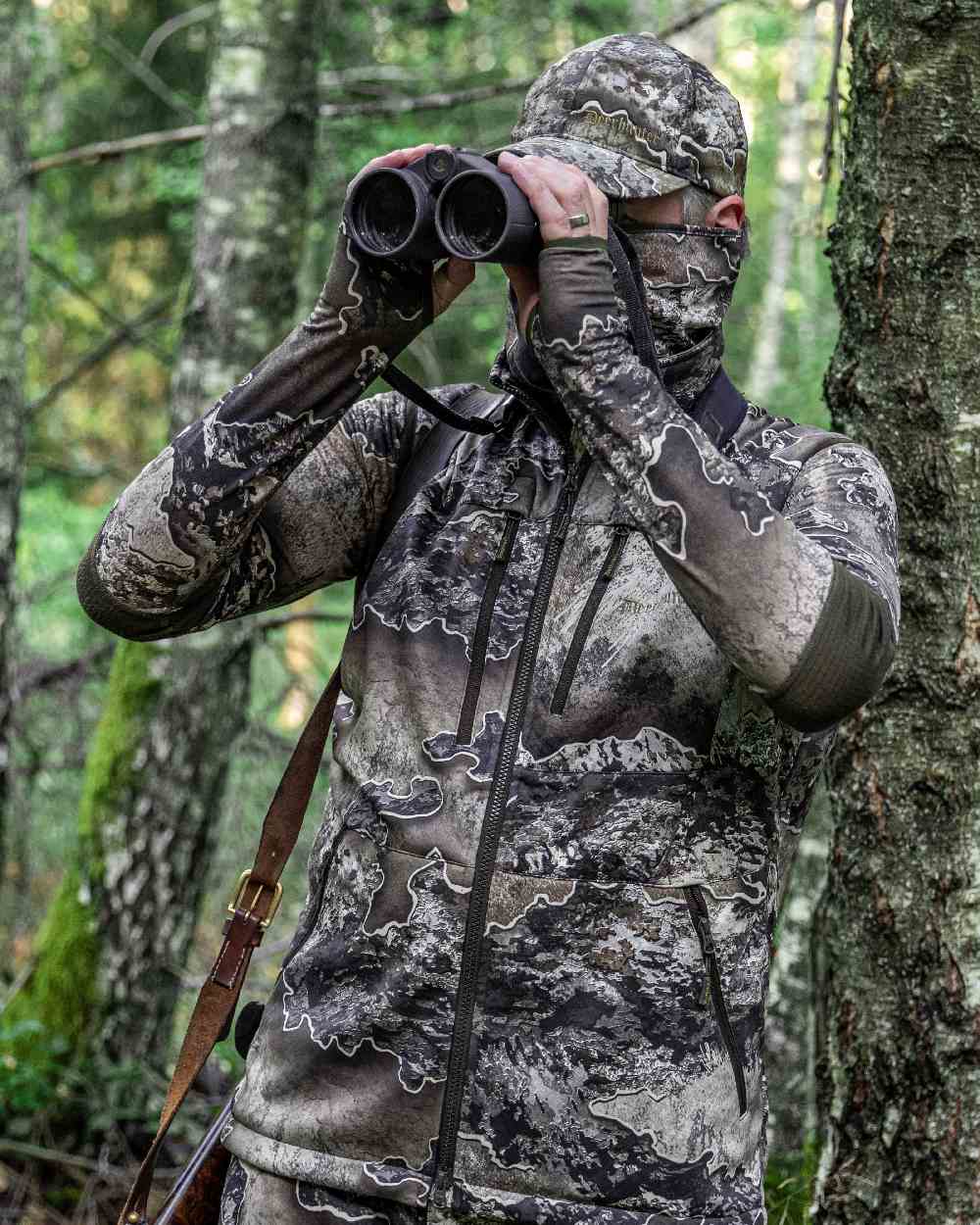 Realtree Excape coloured Deerhunter Excape Softshell Waistcoat on forest background 