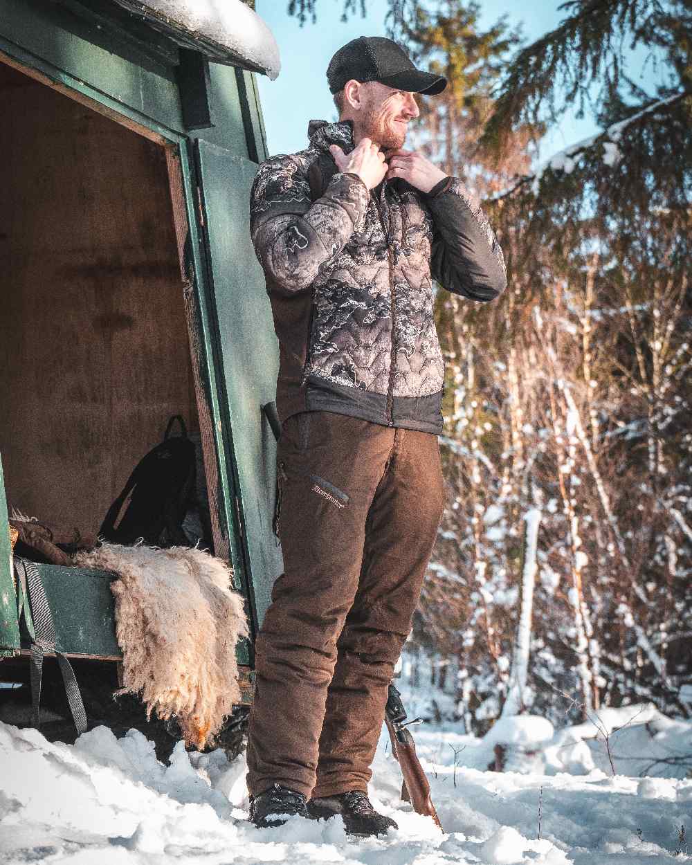 Art Green coloured Deerhunter Excape Winter Waterproof Trousers on snow background 