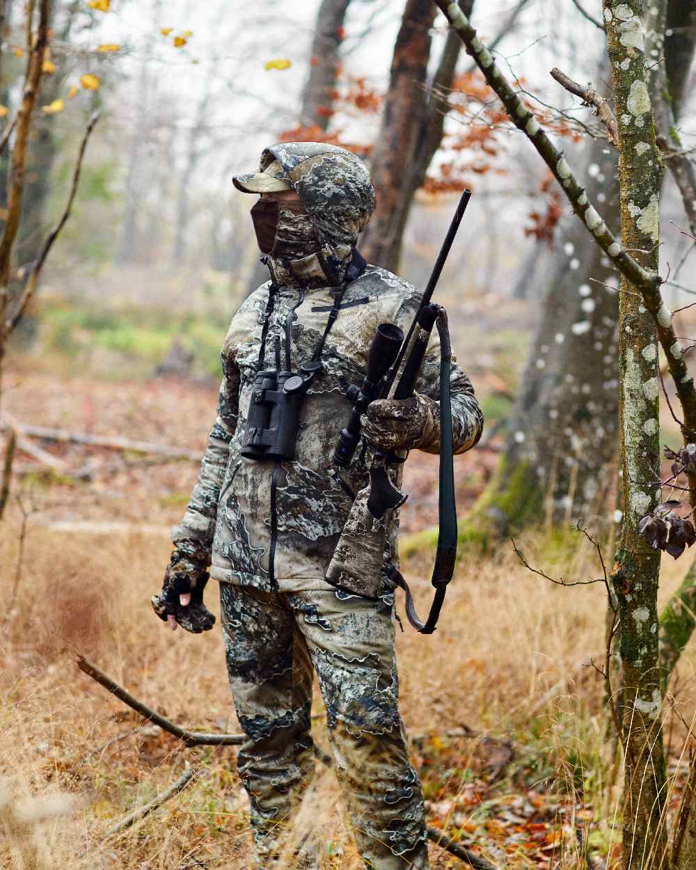 Realtree Excape coloured Deerhunter Excape Winter Waterproof Trousers on forest background 
