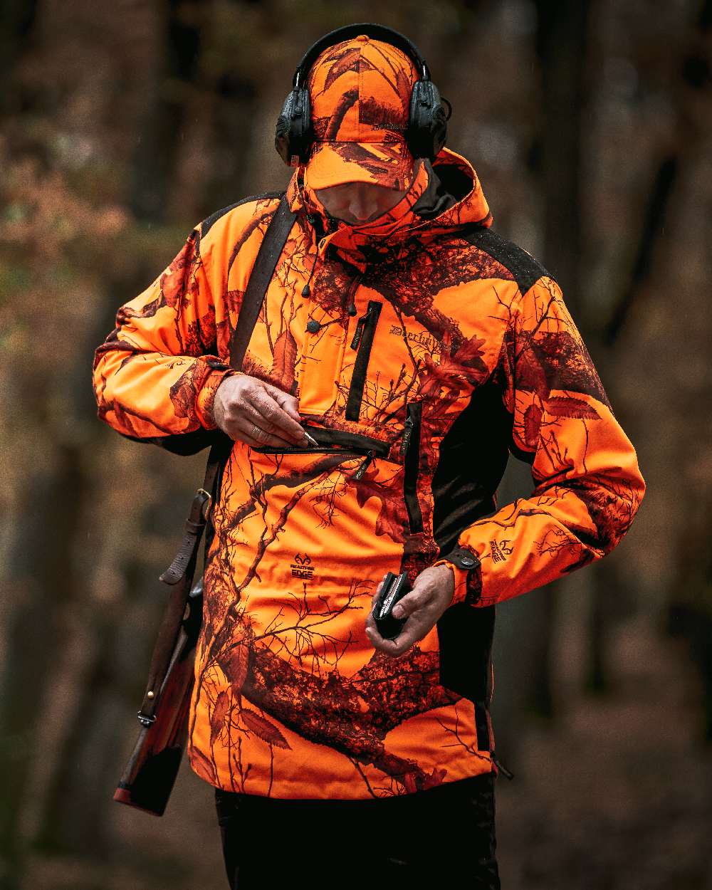 Realtree Edge Orange Coloured Deerhunter Explore Waterproof Smock on blurry background 