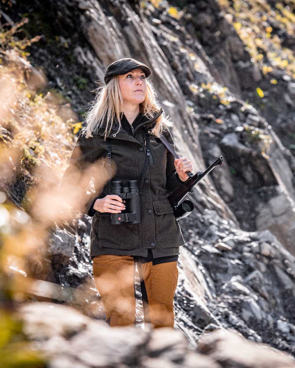 Elmwood coloured Deerhunter Flat Cap on rock background 