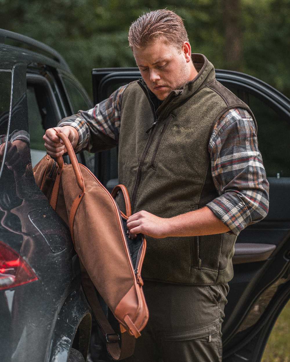 Graphite Green coloured Deerhunter Gamekeeper Bonded Fleece Waistcoat on car background 