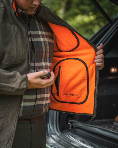 Canteen Orange coloured Deerhunter Gamekeeper Reversible Bonded Fleece Jacket on blurry background 