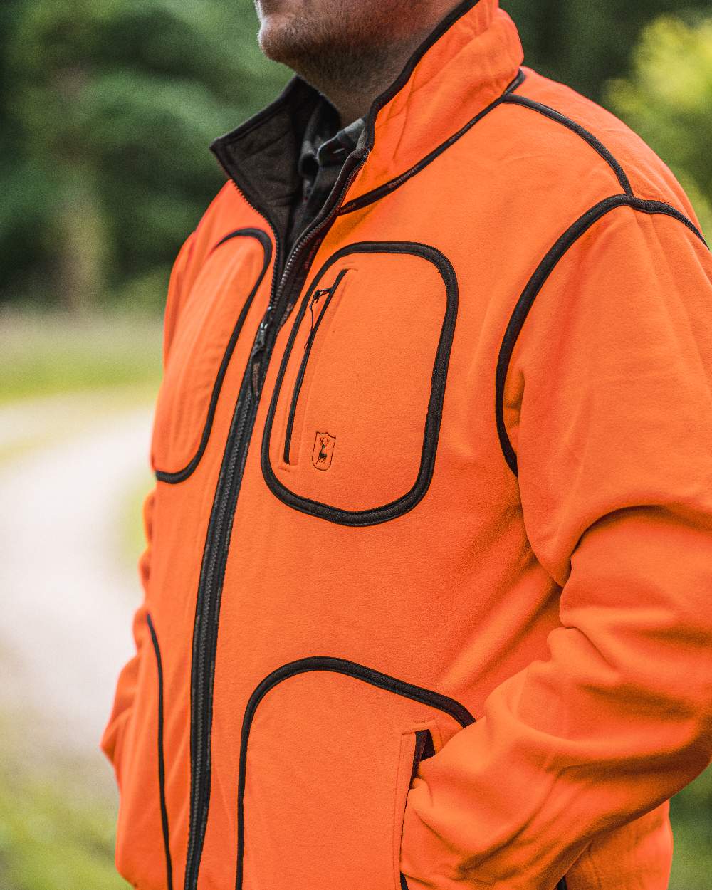 Canteen Orange coloured Deerhunter Gamekeeper Reversible Bonded Fleece Jacket on blurry background 