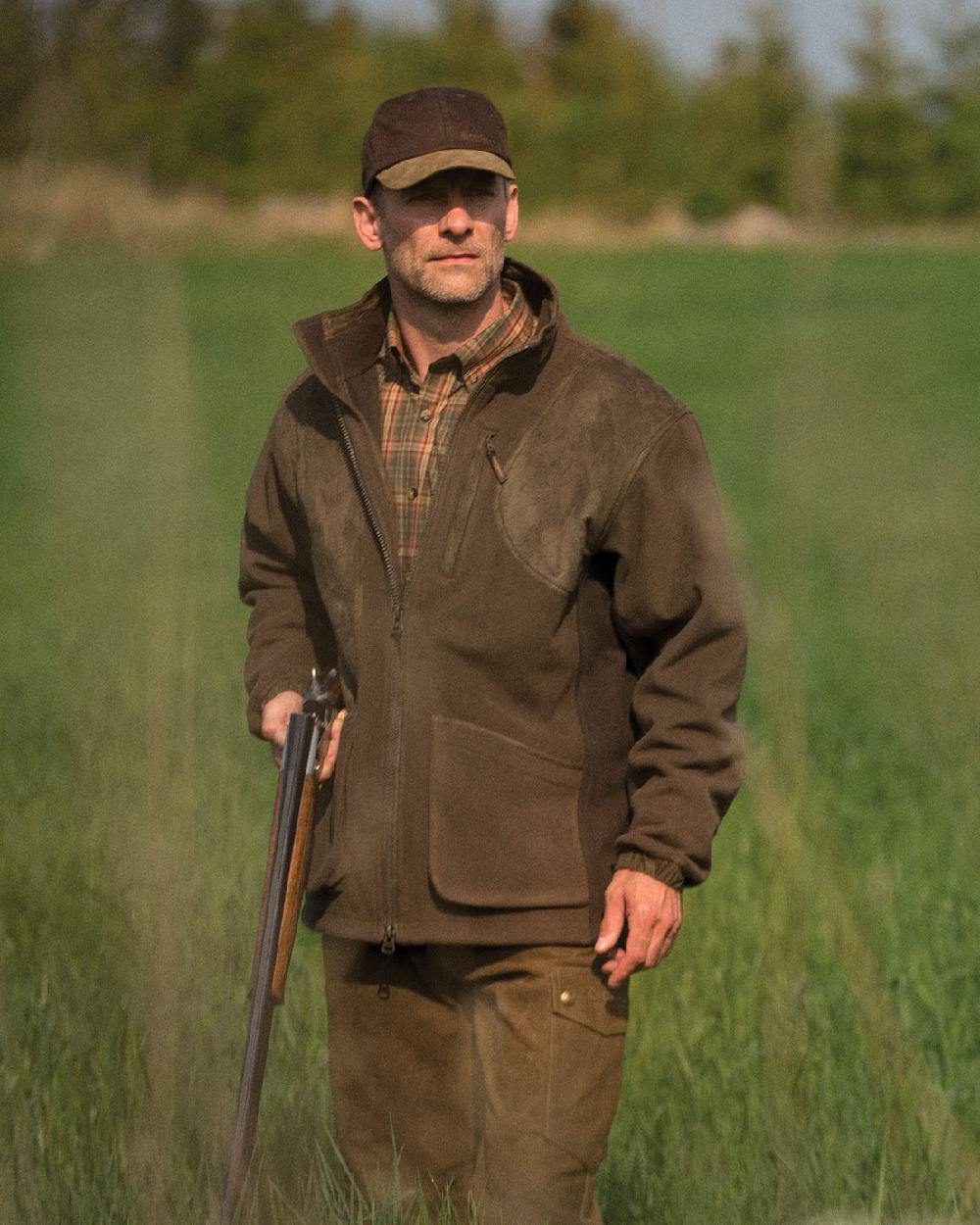 Graphite Green Coloured Deerhunter Gamekeeper Shooting Jacket on grass background 