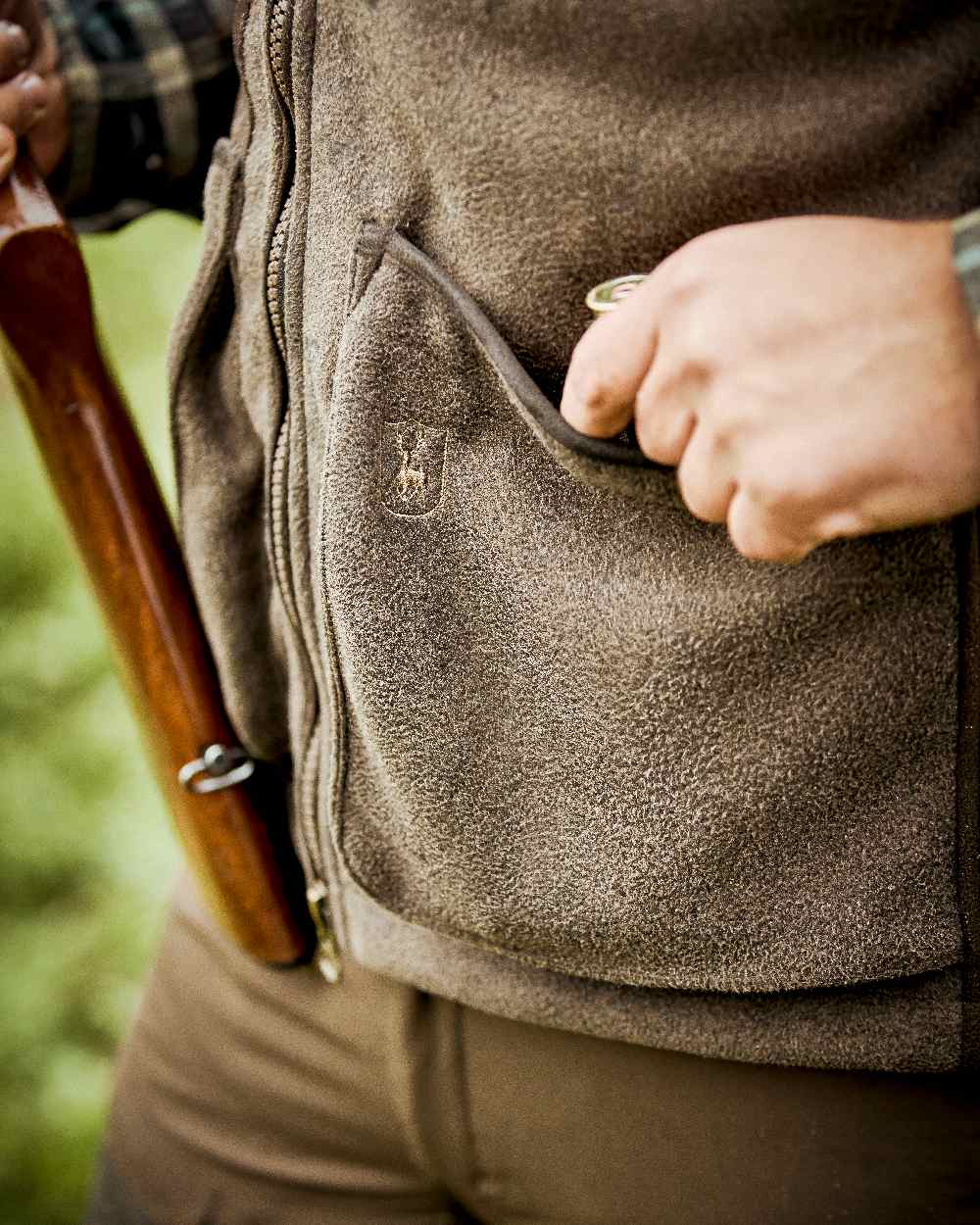 Graphite Green Coloured Deerhunter Gamekeeper Shooting Waistcoat on blurry background 