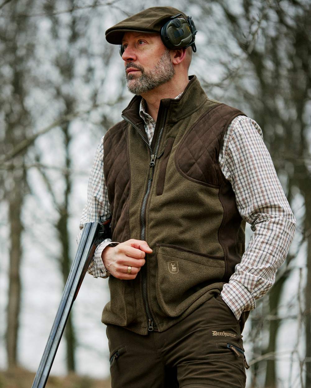 Graphite Green Coloured Deerhunter Gamekeeper Shooting Waistcoat on forest background 