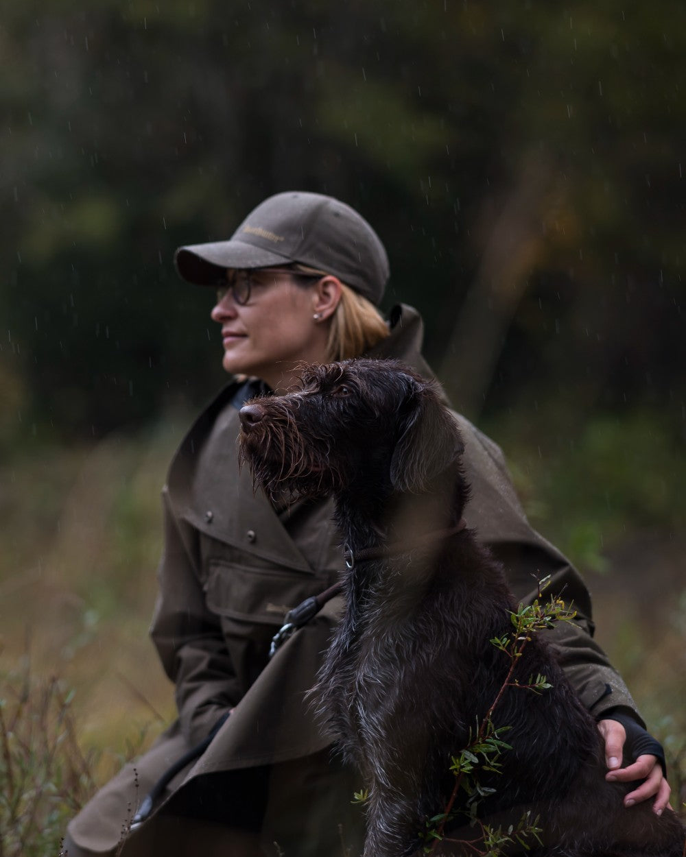 Canteen Coloured Deerhunter Ladies Waterproof Rain Poncho on blurry background 