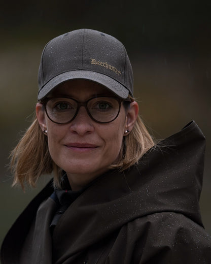 Canteen Coloured Deerhunter Ladies Waterproof Rain Poncho on blurry background 