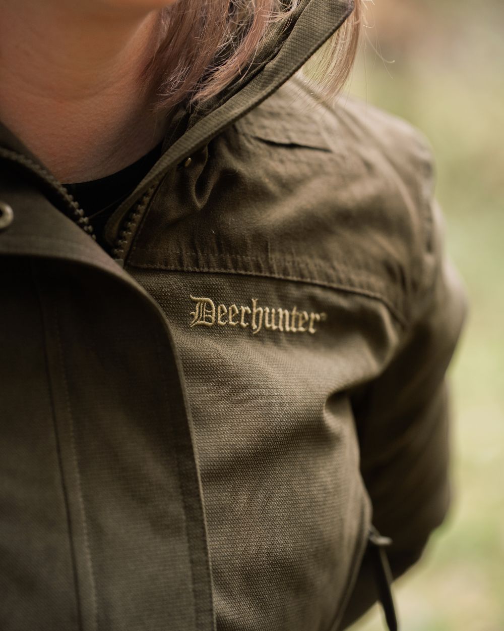 Tarmac Green coloured Deerhunter Lady Eagle Winter Jacket on blurry background 