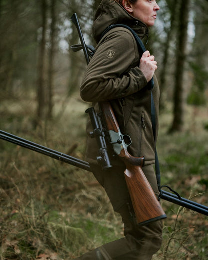 Art Green coloured Deerhunter Lady Excape Softshell Trousers on forest background 