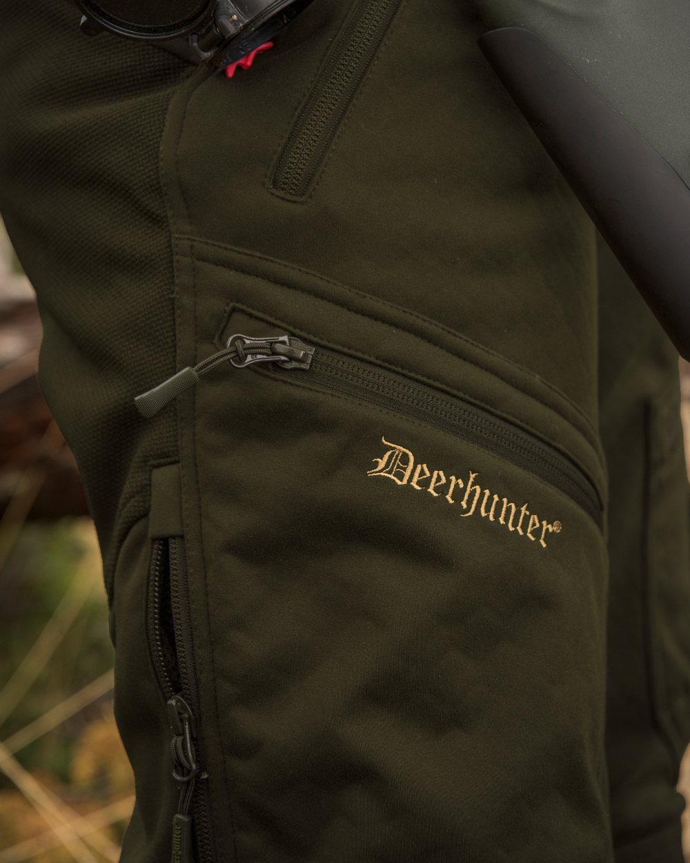 Art Green coloured Deerhunter Lady Excape Softshell Trousers on forest background 