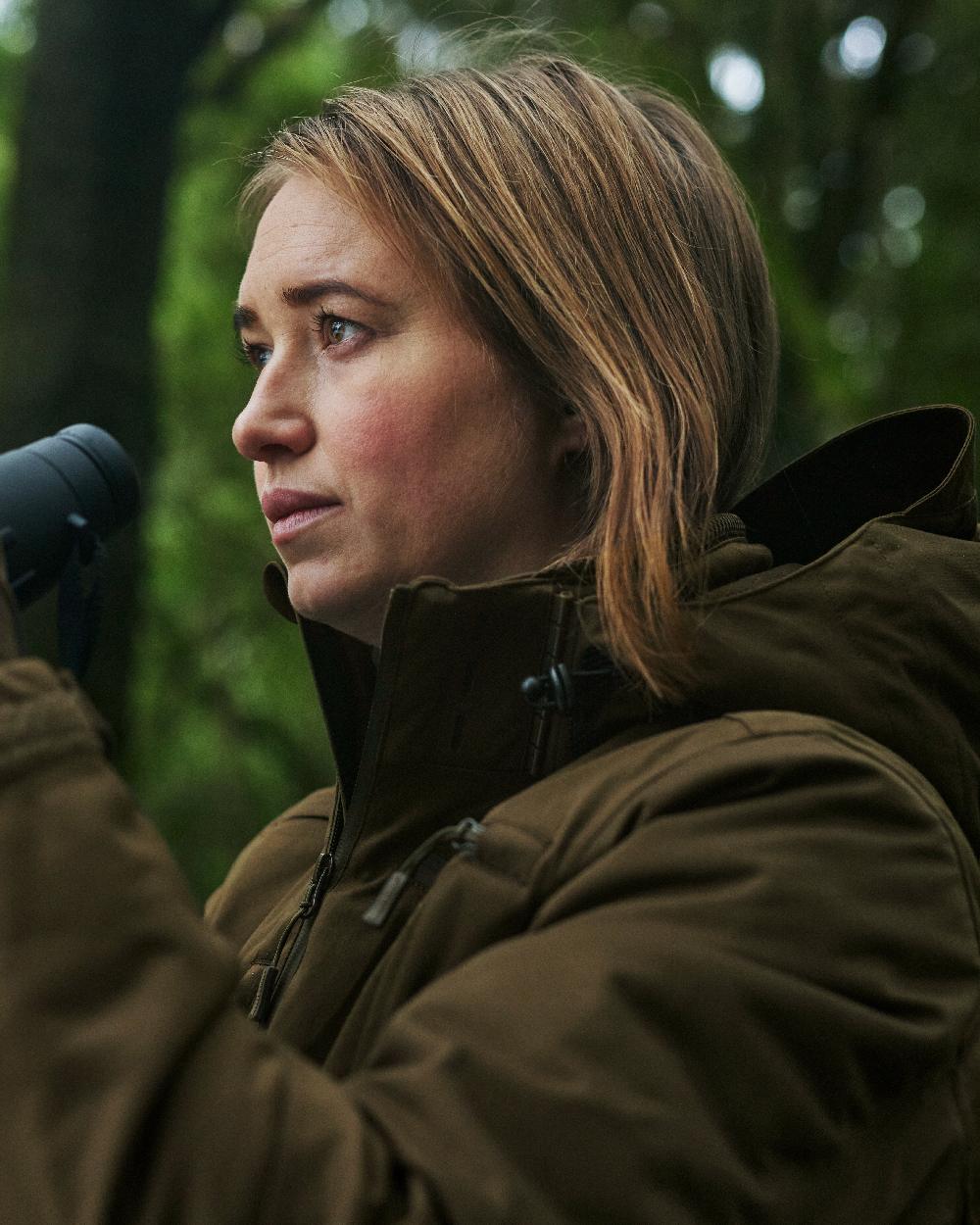 Art Green coloured Deerhunter Lady Excape Winter Jacket on blurry background 