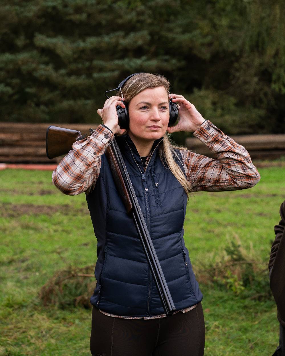 Dark Blue Coloured Deerhunter Lady Heat Padded Waistcoat on forest background 