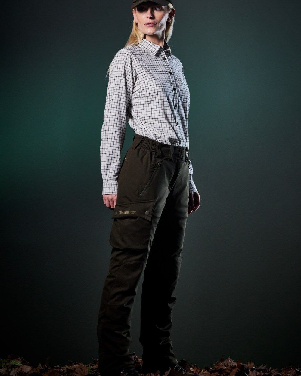 Art Green coloured Deerhunter Lady Muflon Pro Trousers on forest background 