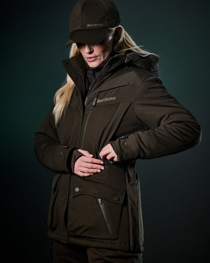Art Green coloured Deerhunter Lady Muflon Pro Winter Jacket on forest background 