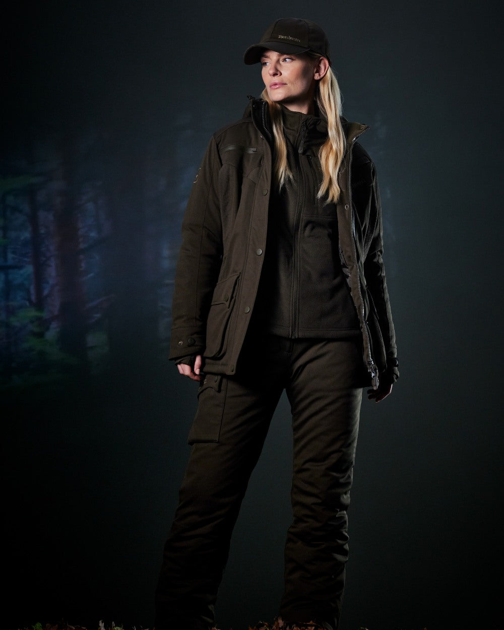 Art Green coloured Deerhunter Lady Muflon Pro Winter Jacket on forest background 