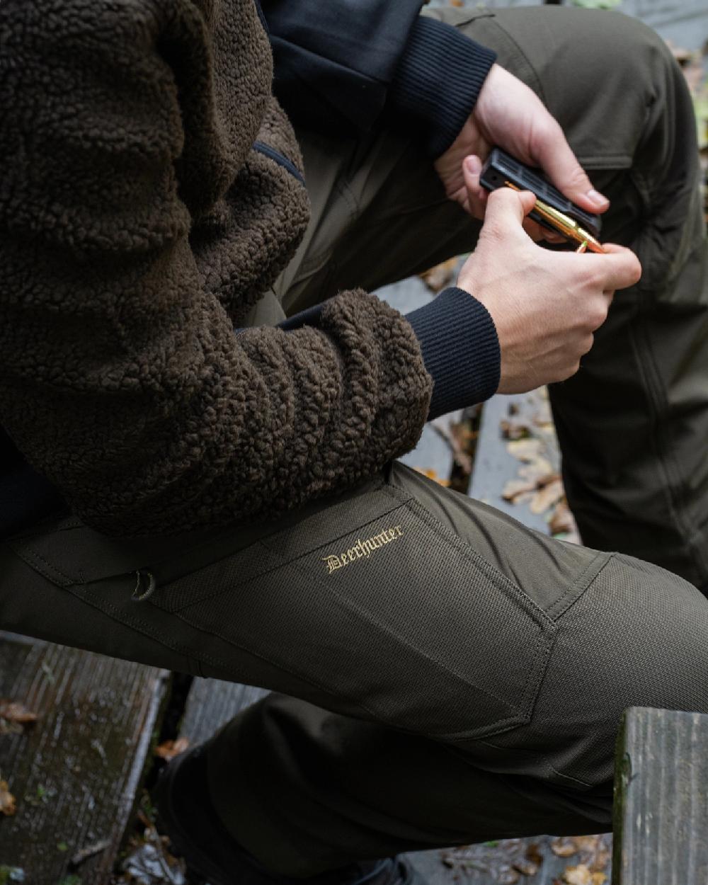 Bark Green coloured Northward Trousers on land background 