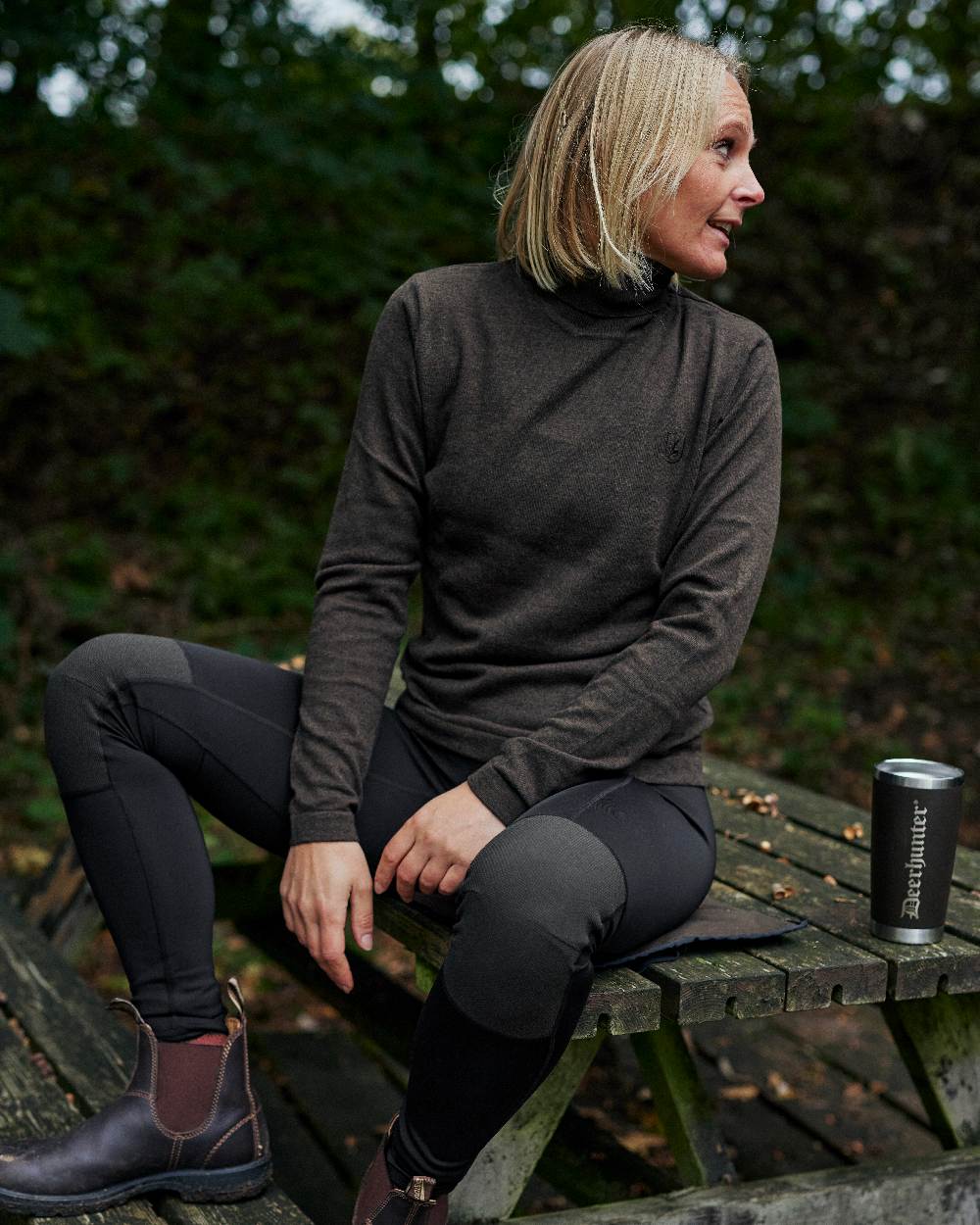 Black coloured Deerhunter Lady Reinforced Tights on wooden bench background 