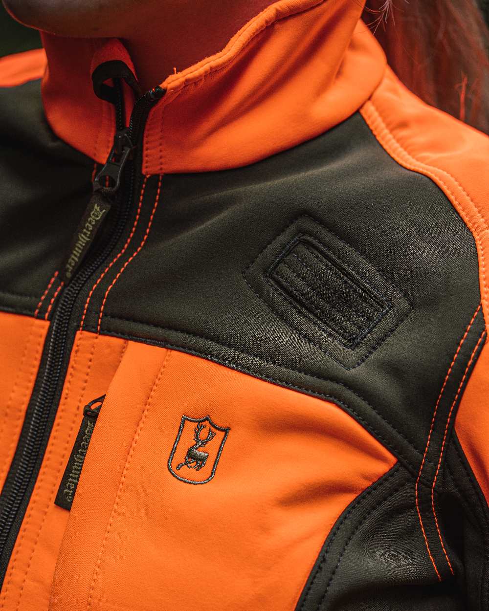 Orange coloured Deerhunter Lady Roja Softshell Jacket on blurry background 