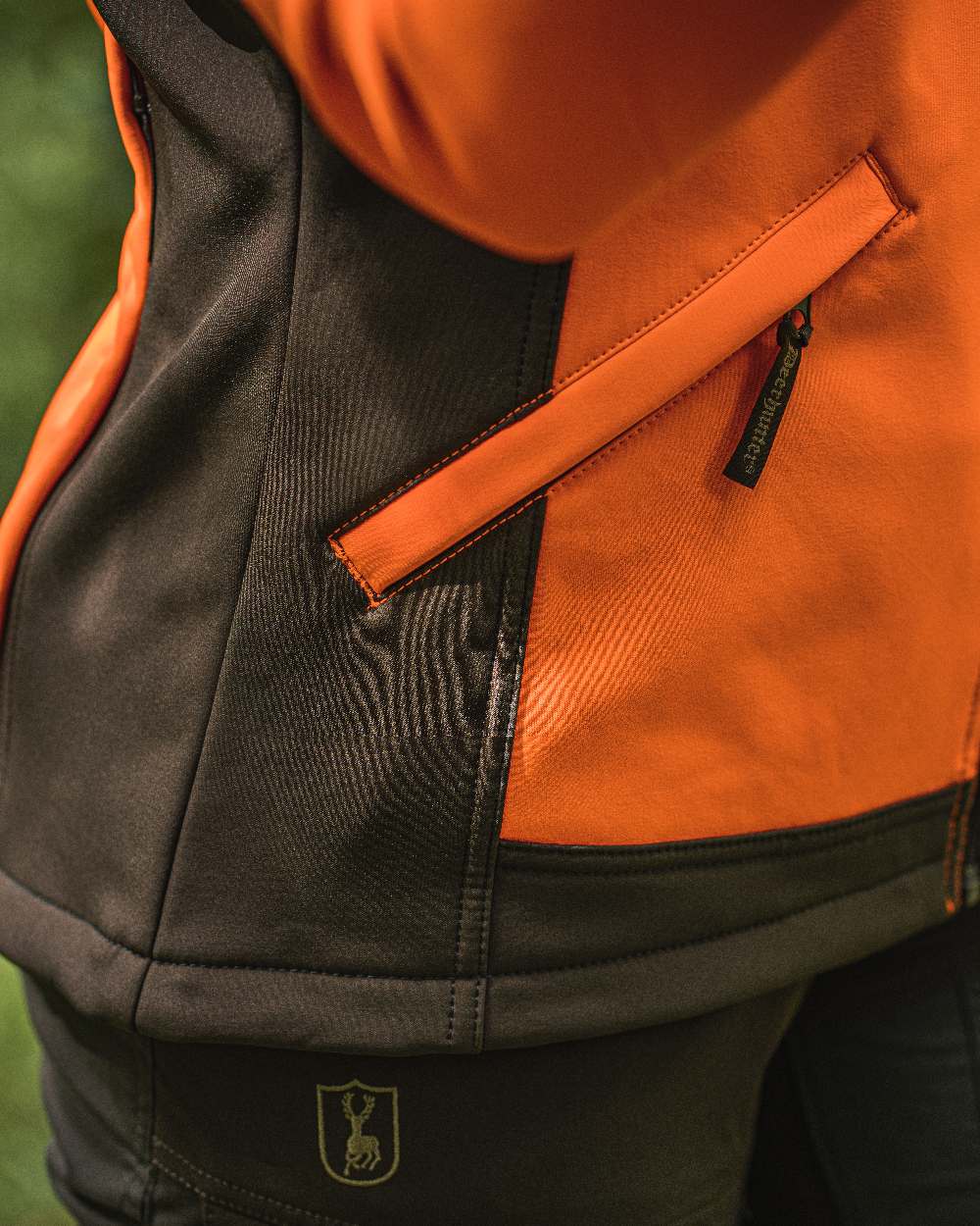Orange coloured Deerhunter Lady Roja Softshell Jacket on blurry background 