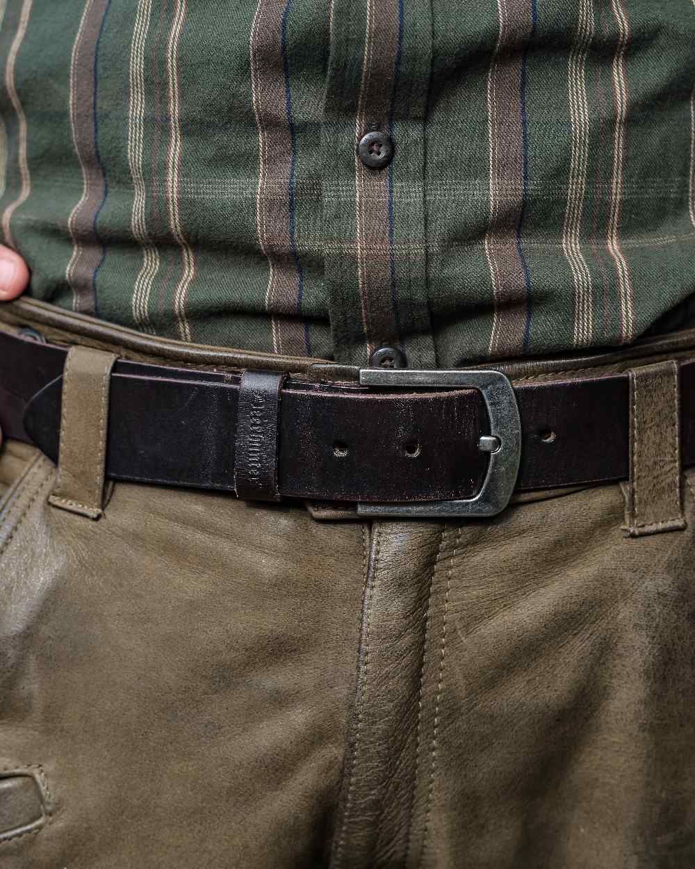 Dark Brown coloured Deerhunter Leather Belt on blurry background 