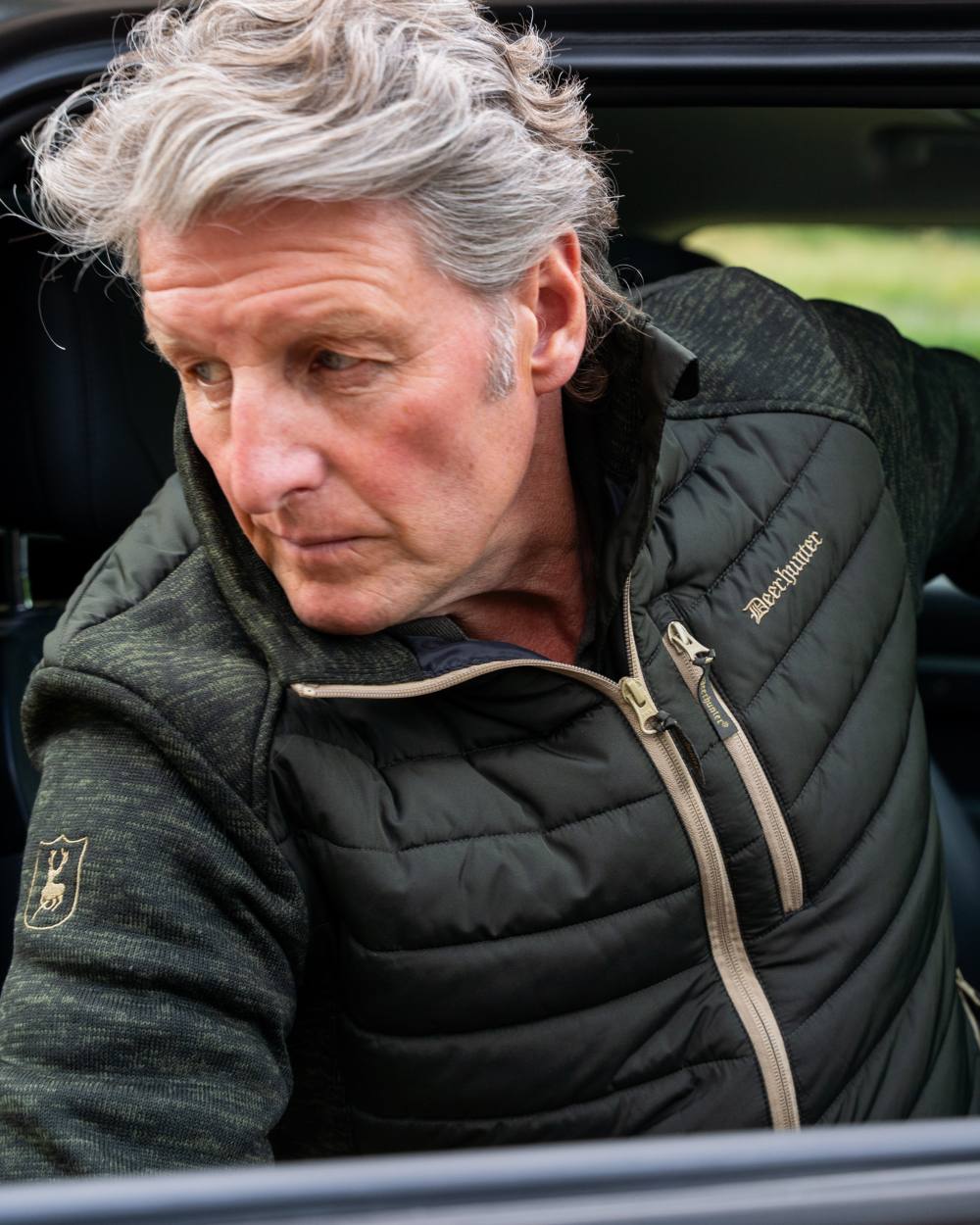 Forest Ember coloured Deerhunter Mens Moor Padded Jacket on car background 