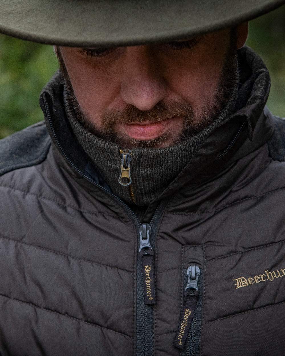 Brown Leaf Coloured Deerhunter Moor Padded Jacket with Knitted Sleeves on blurry background 