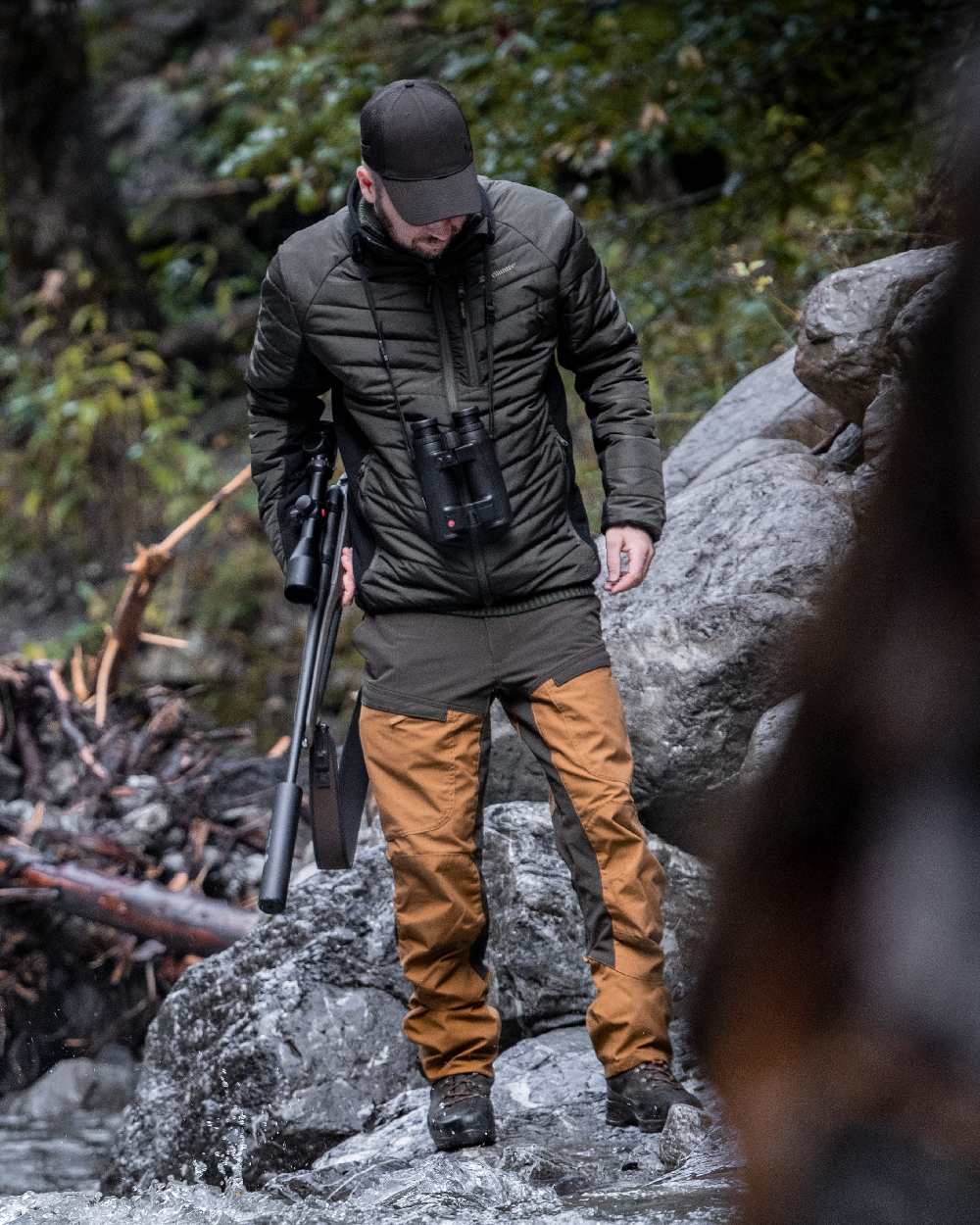 Adventure Green coloured Deerhunter Moor Padded Softshell Jacket on rock background 