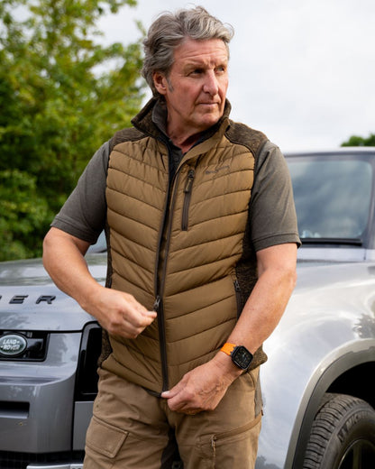 Butternut coloured Deerhunter Mens Moor Padded Waistcoat on car background 