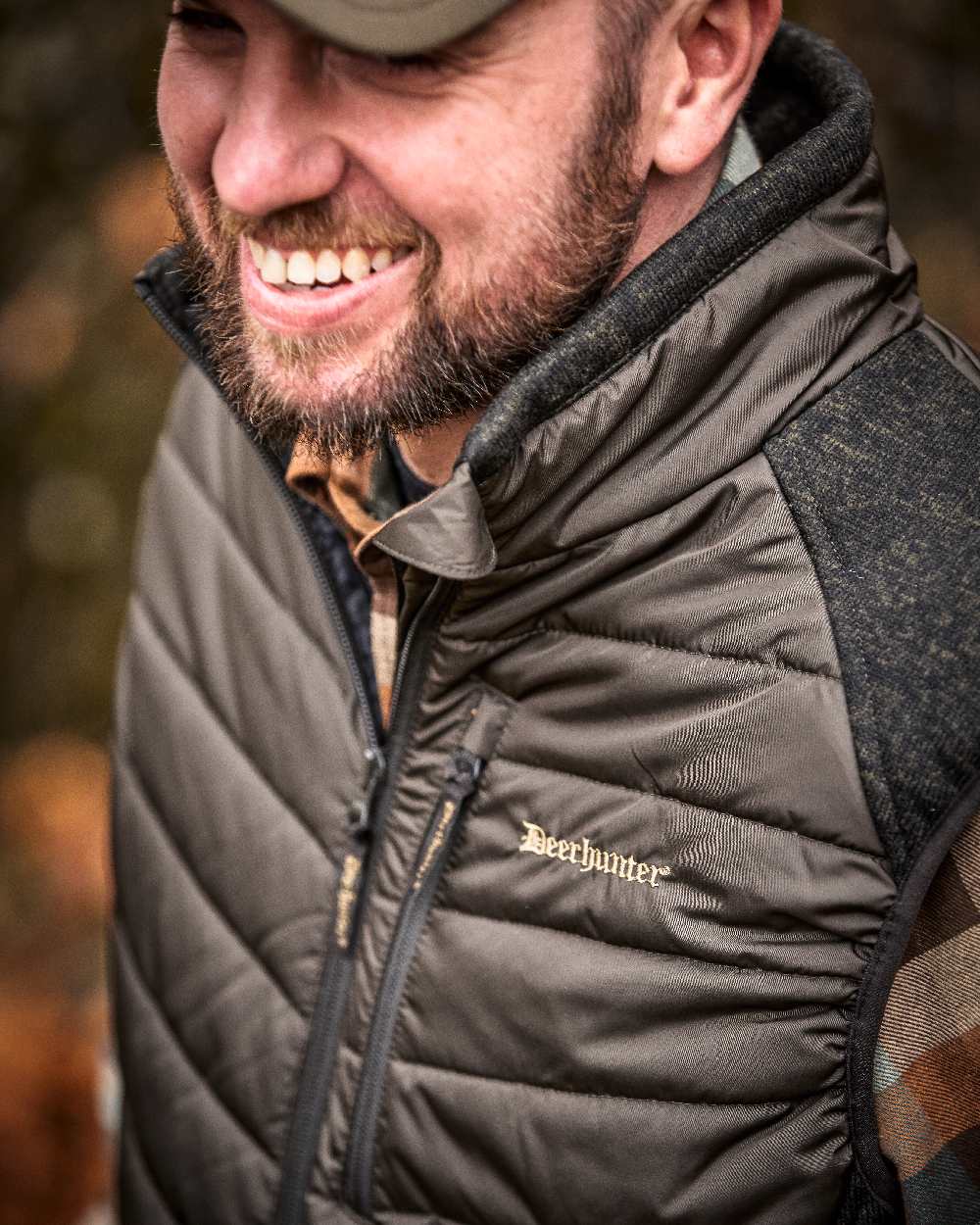 Brown Leaf Coloured Deerhunter Moor Padded Waistcoat with Knit on blurry background 