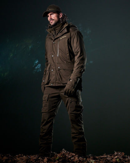 Art Green coloured Deerhunter Mens Muflon Pro Light Jacket on forest background 