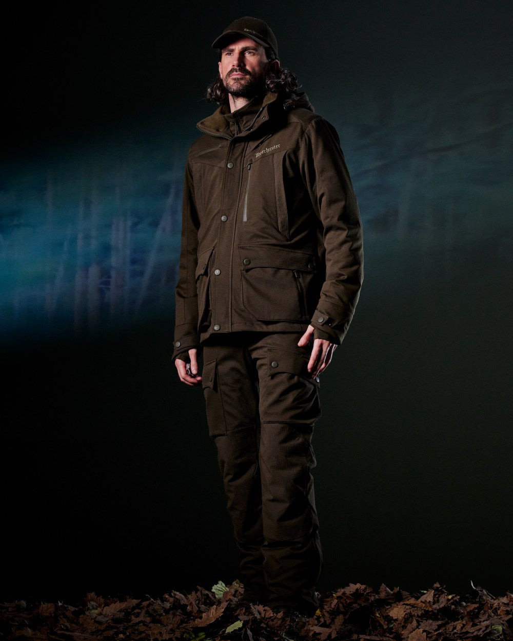 Art Green coloured Deerhunter Mens Muflon Pro Trousers on forest background 