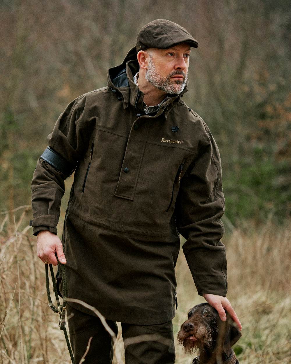Peat coloured Deerhunter Pro Gamekeeper Flatcap on grassy background 
