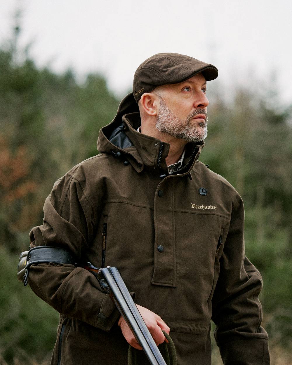 Peat coloured Deerhunter Pro Gamekeeper Flatcap on blurry background 