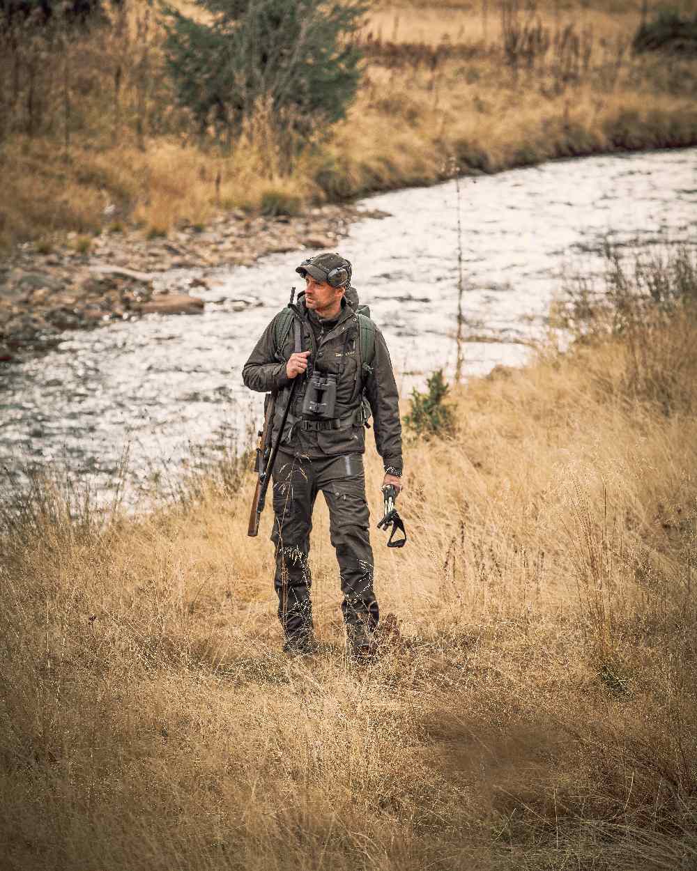 Elmwood coloured Deerhunter Ram Winter Trousers on grassy background 