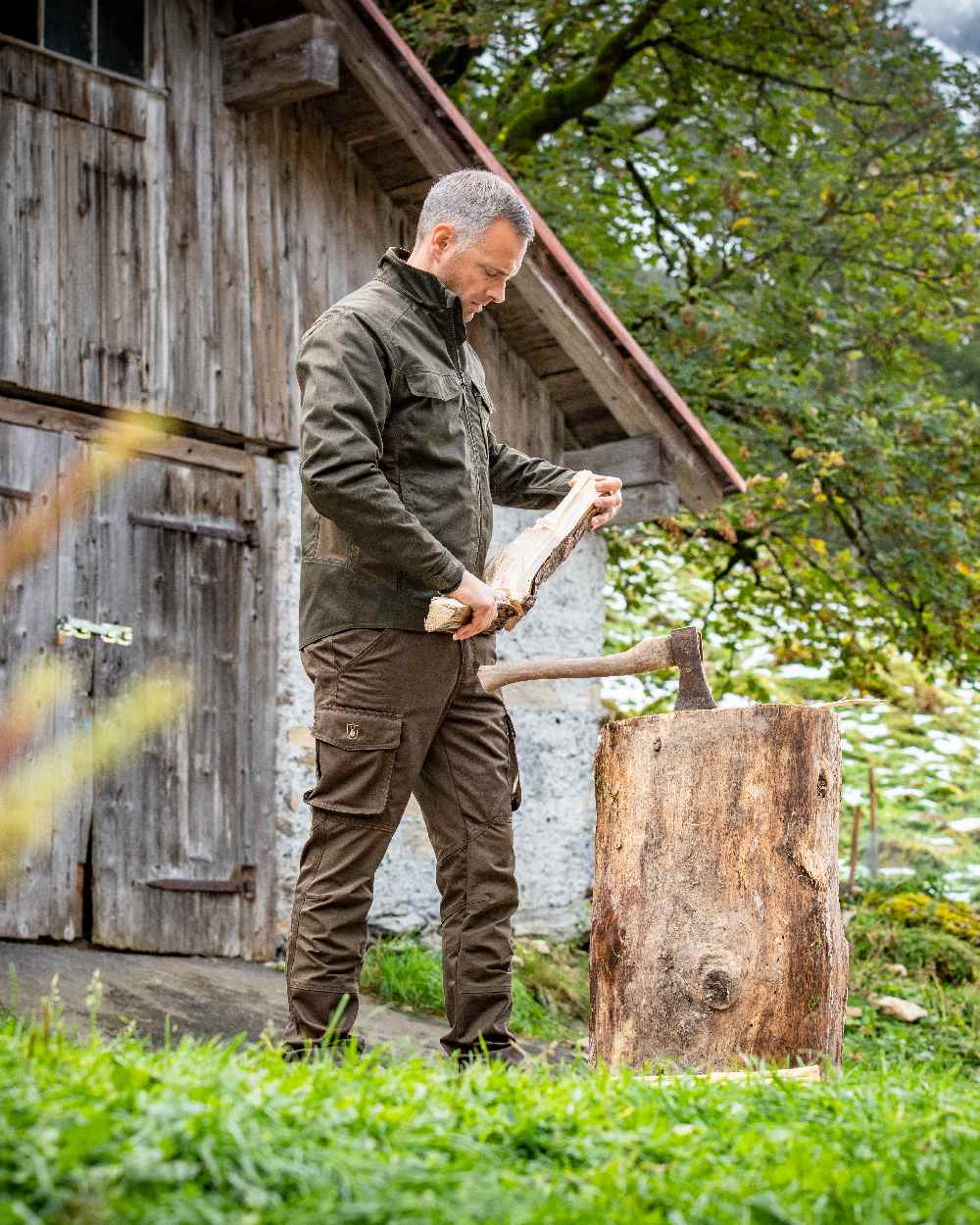 Fallen Leaf Coloured Deerhunter Rogaland Stretch Trousers on log house background 