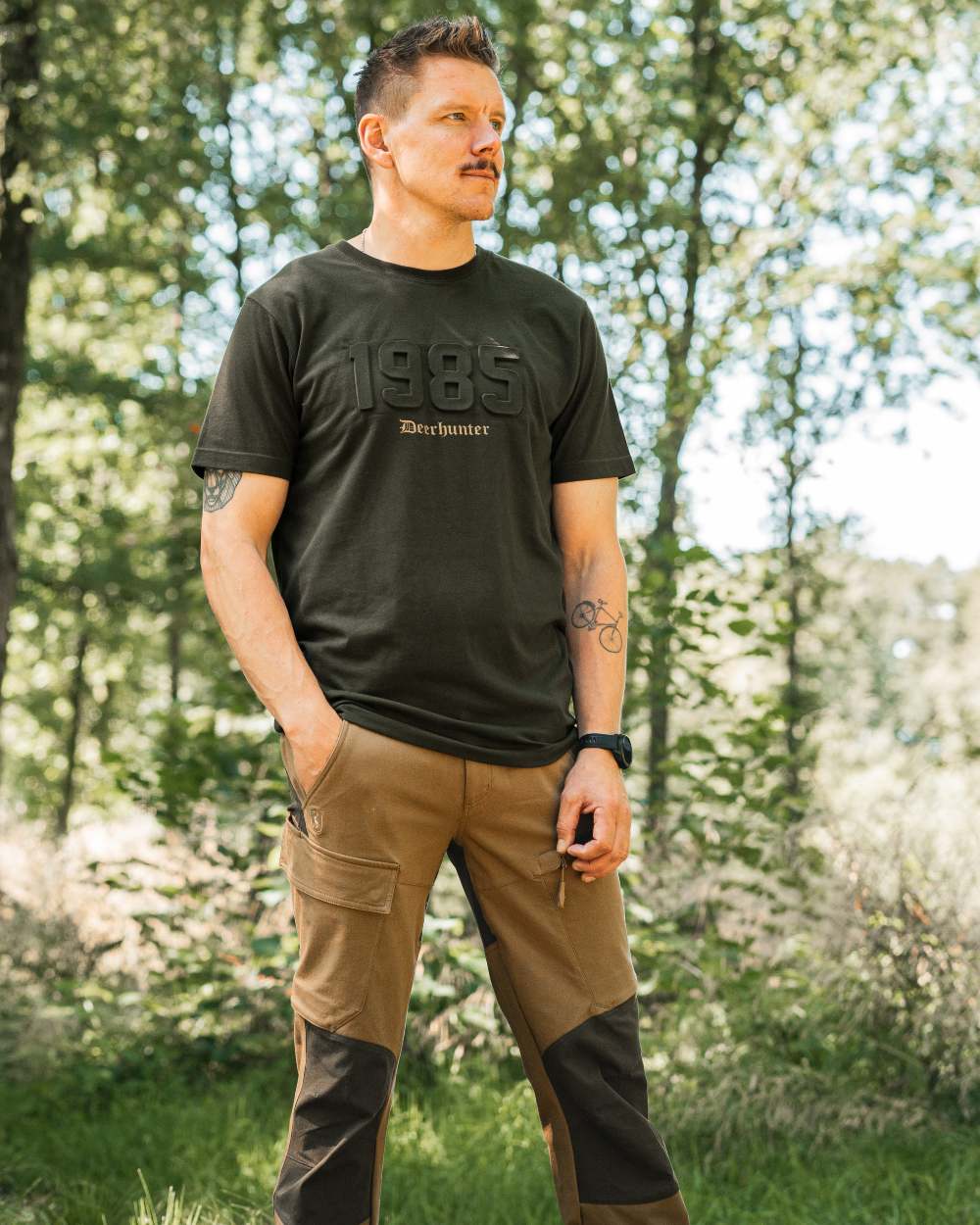 Butternut Fallen Leaf Black coloured Deerhunter Sarek Full Stretch Trousers on forest background 