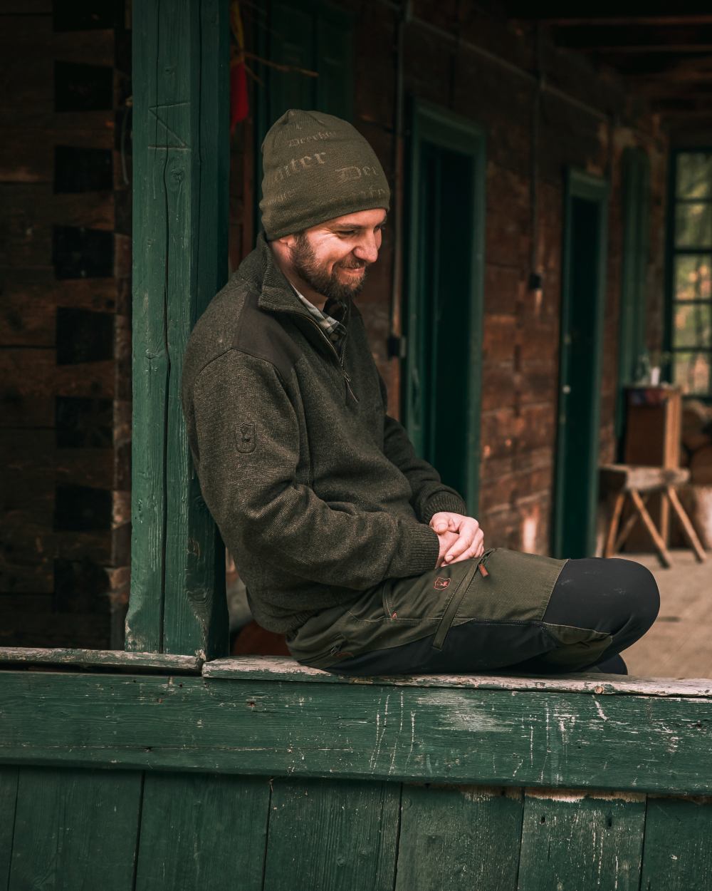 Dark Elm coloured Deerhunter Sheffield Zip Neck Sweater on house background 