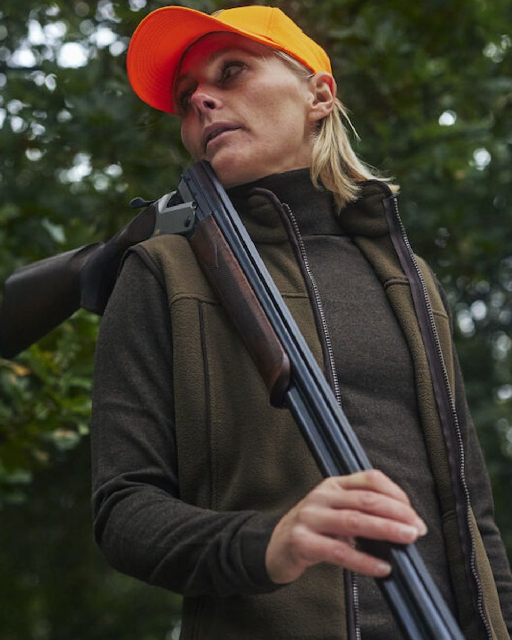 Orange coloured Deerhunter Shield Cap on forest background 