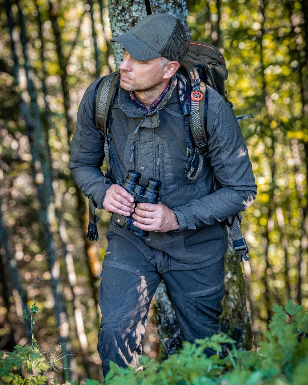 Palm Green coloured Deerhunter Strike Extreme Jacket on forest background 