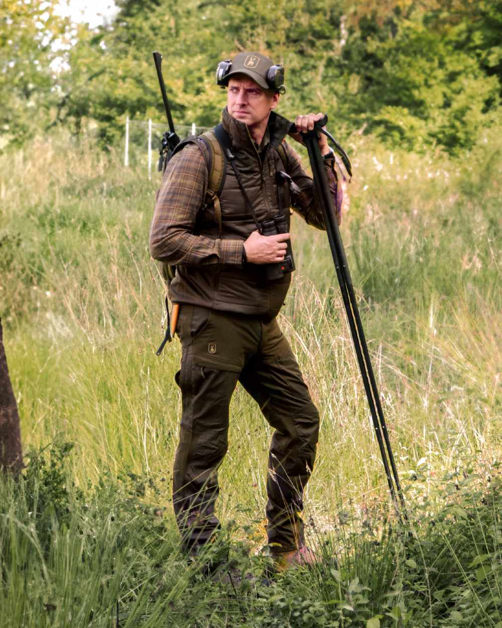 Deep Green coloured Deerhunter Strike Trousers With Membrane on forest background 