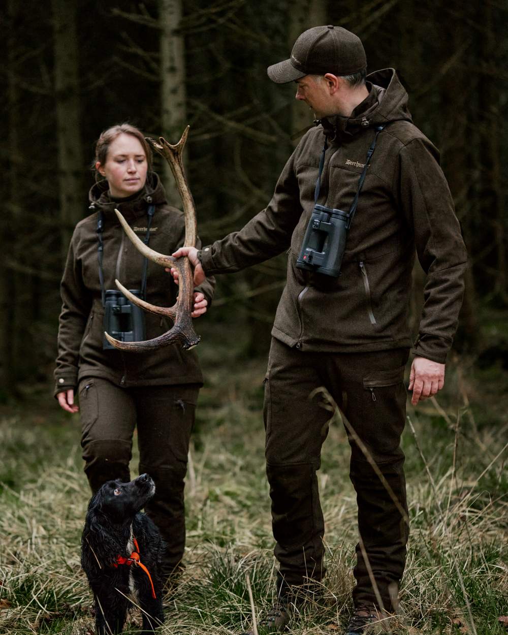 Loden Wood Coloured Deerhunter Tatra Cap With Earflaps On A Forest Background 