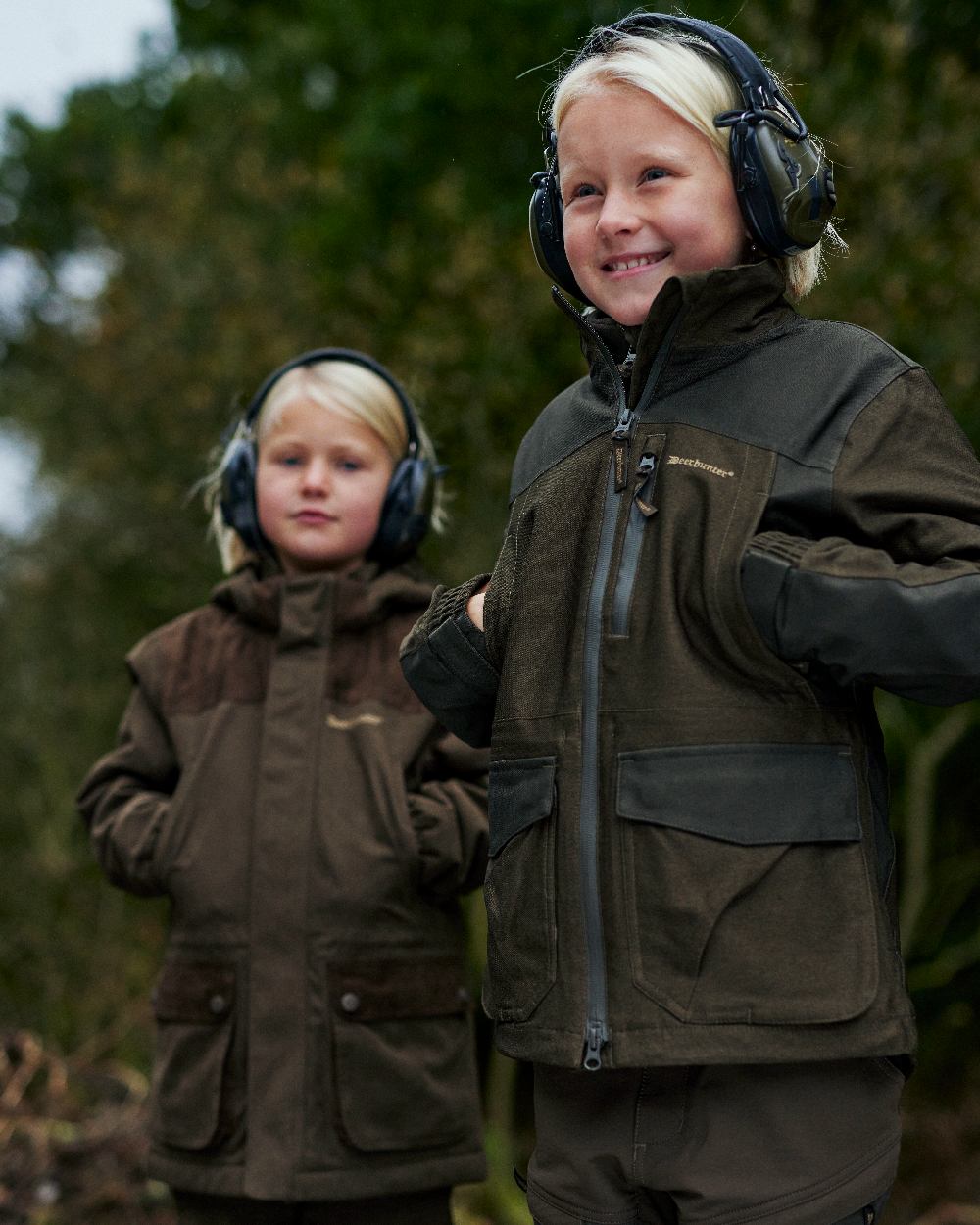 Olive Night Melange coloured Deerhunter Youth Chasse Jacket on forest background 
