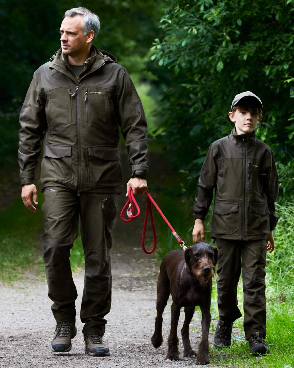Olive Night Melange coloured Deerhunter Youth Chasse Trousers on forest background 